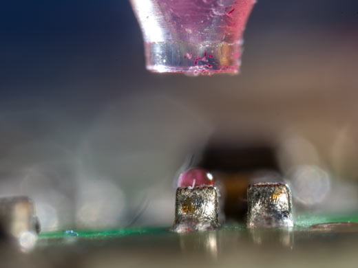 Figure 4: Nanoliter dosing on a circuit board. The drop is small enough to sit on a single component.